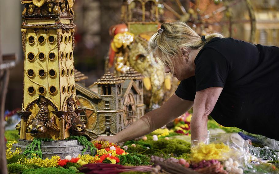 Stephanie Winters fills in the landscaping around a Coney Island themed display as part of the preparations for the annual Holiday Train Show at the New York Botanical Garden in New York, Thursday, Nov. 11, 2021. The show, which opens to the public next weekend, features model trains running through and around New York landmarks, recreated in miniature with natural materials. 