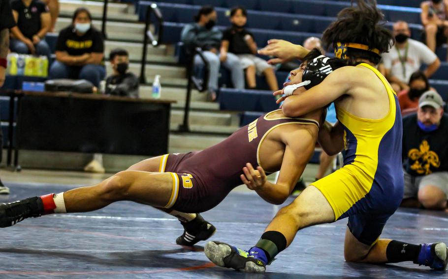 Guam High's Victor Babauta gains the upper hand on Father Duenas Memorial's Sebastian Riley during Saturday's wrestling dual meets. Babauta edged Riley by decision 14-13.