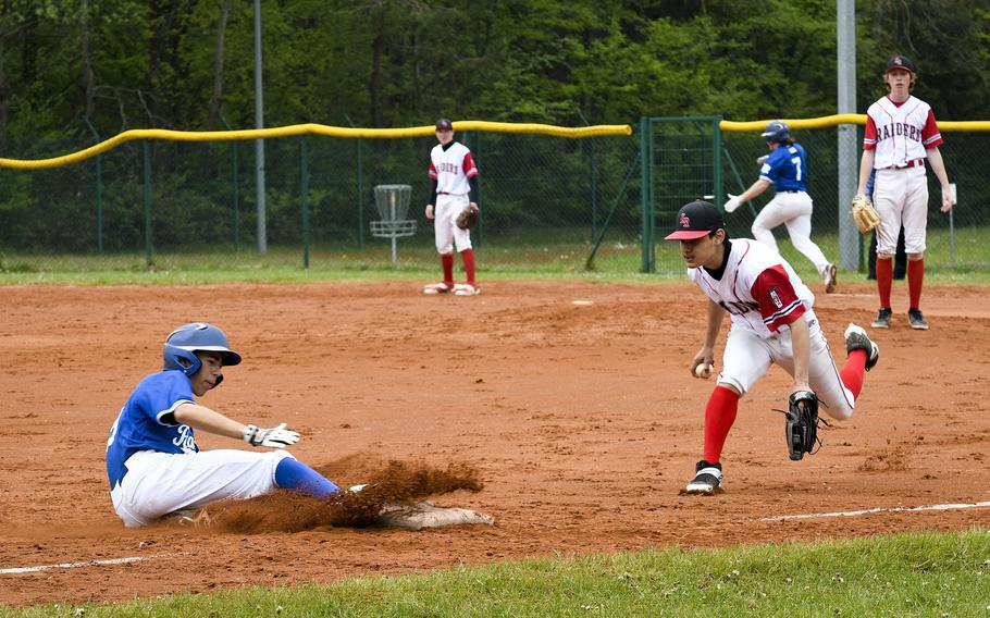 Ramstein's Conor McGinty slides into third base before Kaiserslautern's third baseman can reach him in a game Saturday, April 30, 2022, in Kaiserslautern, Germany.