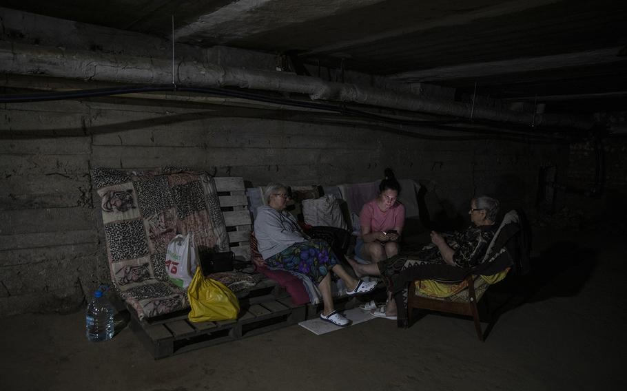 Tatiana Zhivtsova, 62, left, with her daughter Svitlana Zhivtsova, 40, and her mother, Alla Zhivtsova, 85, as they shelter underground in their apartment building in Nikopol on Aug. 19, 2022.