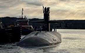 Tugboats guide the attack submarine USS Newport News away from the pier at Naval Submarine Base New London in Groton, Conn., March 12, 2025. Newport News made a port call in Iceland on July 9, marking the first time a nuclear-powered submarine has visited Icelandic shores, the Navy said.