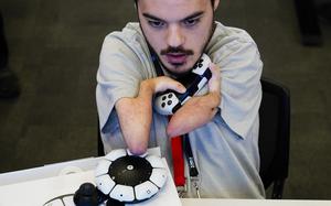 Martin Shane uses a Sony Access controller, left, to play a video game at Sony Interactive Entertainment headquarters Sept. 28, 2023, in San Mateo, Calif. 