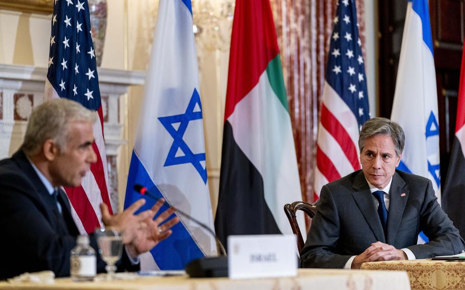 Israeli Foreign Minister Yair Lapid, left, accompanied by Secretary of State Antony Blinken, right, speaks at a joint news conference at the State Department in Washington, Wednesday, Oct. 13, 2021.