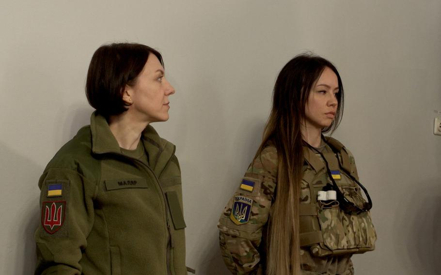 Hanna Maliar, Ukraine’s deputy defense minister,left,  listens as Sandra Andersen Eira talks about why she left her home in Norway to join Ukrainian forces fighting the Russian invasion. 