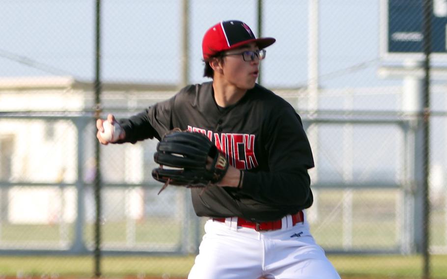 Noah Berhow throws to first.