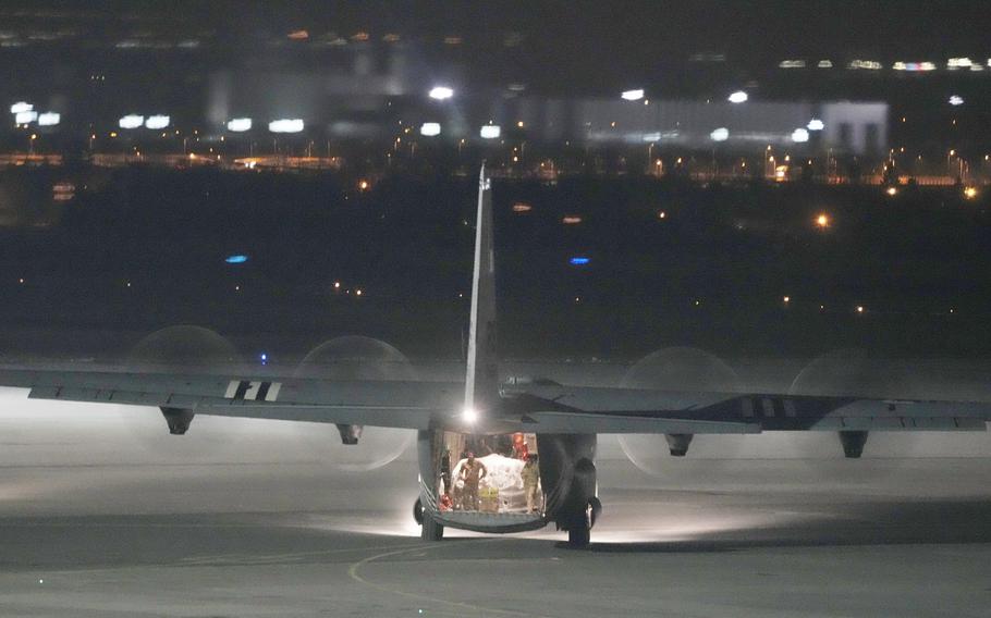 U.S. Army soldiers unload equipment from a transport plane at the Rzeszow-Jasionka airport in southeastern Poland, on Friday, Feb. 4, 2022.