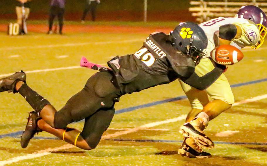 Guam High's Cameron Brantley strips the ball from George Washington's Tristen Hayes.