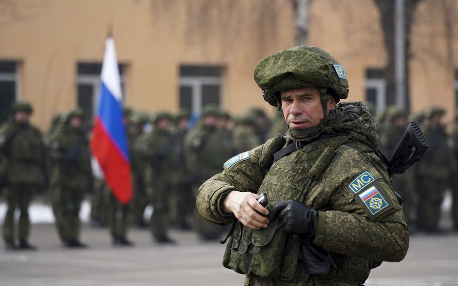 A Russian officer, part of the Collective Security Treaty Organization peacekeepers, attends a ceremony in Almaty, Kazakhstan, on Thursday, Jan. 13, 2022, as the Russian-led security group began withdrawing its troops from Kazakhstan