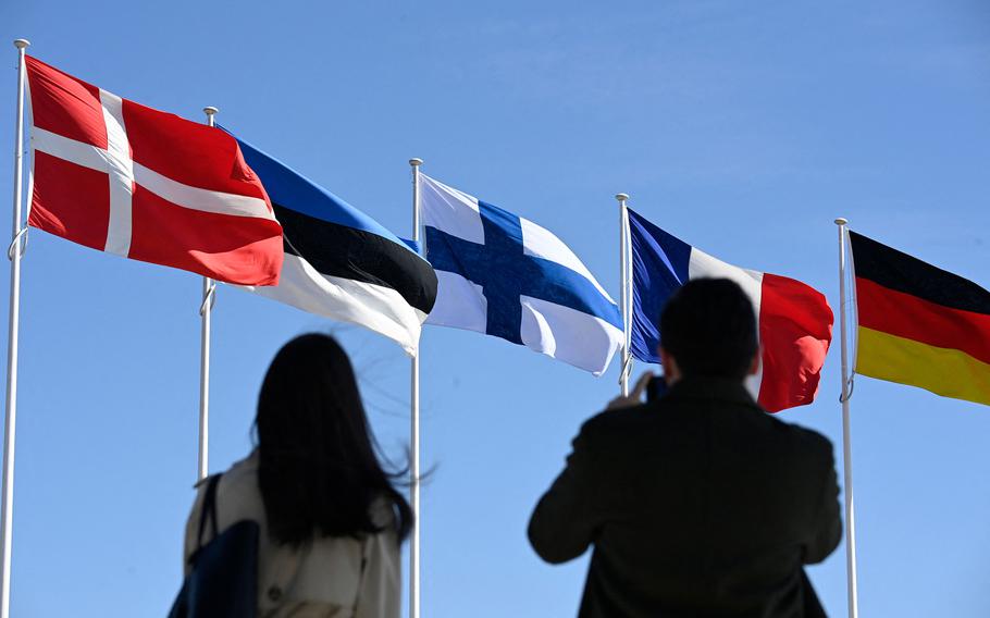Finland’s national flag (center) is raised in a ceremony at NATO headquarters in Brussels, on April 4, 2023. Finland became the 31st member of NATO, wrapping up its historic strategic shift with the deposit of its accession documents to the alliance. 