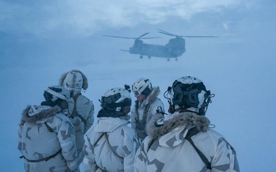 U.S. and Danish special operators brace for the rotor wash from the CH-47G. 