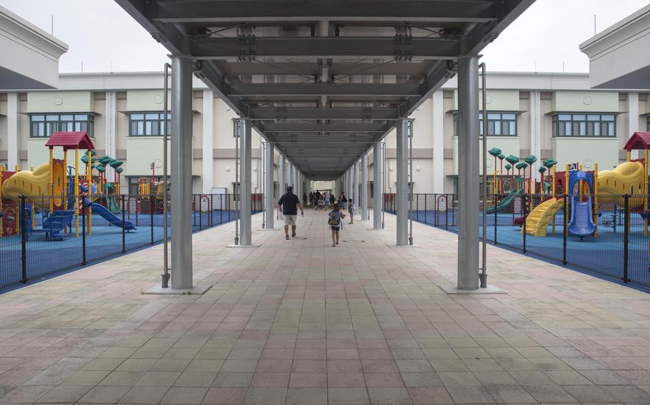 Students and parents walk between playground equipment at Matthew C. Perry Primary School and Iwakuni Elementary School at Marine Corps Air Station Iwakuni, Japan, Aug. 30, 2017. M.C. Perry is first in line to offer universal prekindergarten to U.S. military families stationed overseas.