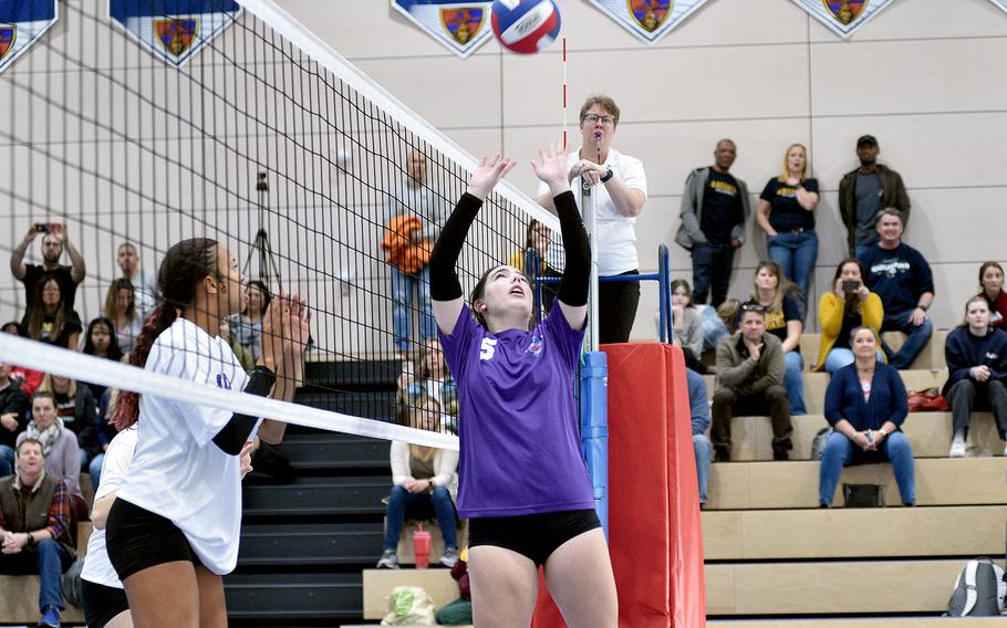 Team Purple’s Georgia Bryant, center, sets the ball on Saturday during a DODEA-Europe all-star volleyball match at Ramstein High School on Ramstein Air Base, Germany. Team White’s Sophia Fisher of Aviano, left, gets ready to defend at the net.