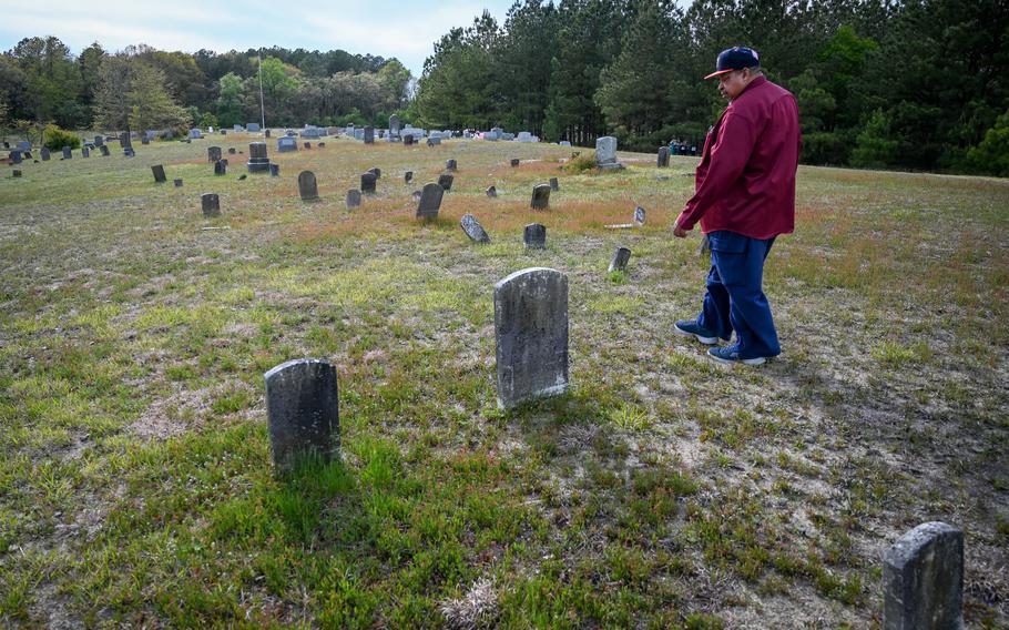 Rudolph Eugene Stanley, 72, walks through Zion Cemetery, where many of the community's founders and eight generations of its residents are buried. Stanley grew up in San Domingo and is the community's leading geneaologist.