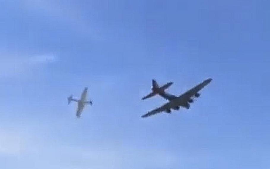 A video screen grab shows a Bell P-63 Kingcobra, left, just seconds before it rams into the right wing of a Boeing B-17 Flying Fortress during an airshow in Dallas on Saturday, Nov. 12, 2022.