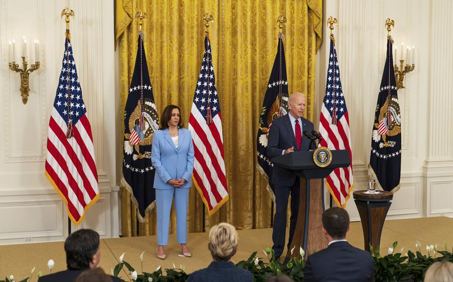 President Joe Biden speaks while Vice President Kamala Harris looks on in the East Room of the White House on June 24, 2021. 