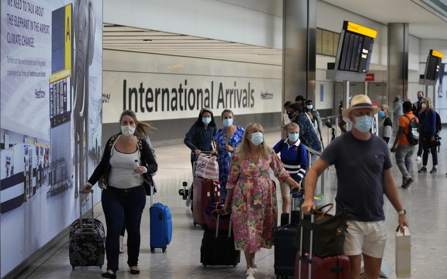 Passengers arrive at Terminal 5 of Heathrow Airport in London, Aug. 2, 2021. 