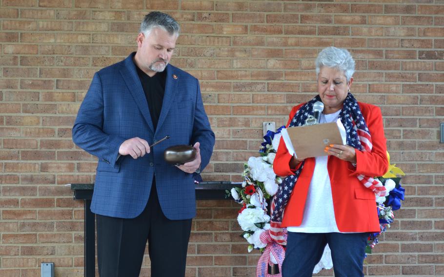 Margie Taylor, whose son Spc. Joey Lenz died at Fort Cavazos, Texas, reads the names of other soldiers who died at the Army post as Brian Tally, a Marine veteran, rings a bell during an event on Tuesday, May 23, 2023, at Central Texas State Veterans Cemetery in Killeen. Taylor held the event to raise awareness about noncombat deaths in the military. 