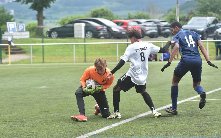 Black Forest Academy goalkeeper Nate Maddox gets to the ball before Vicenza's Raul Carrillo in the Falcons' 4-1 victory in the fifth-place game of the DODEA European Division II boys soccer championships Wednesday, May 22, 2024, at Reichenbach-Steegen, Germany.