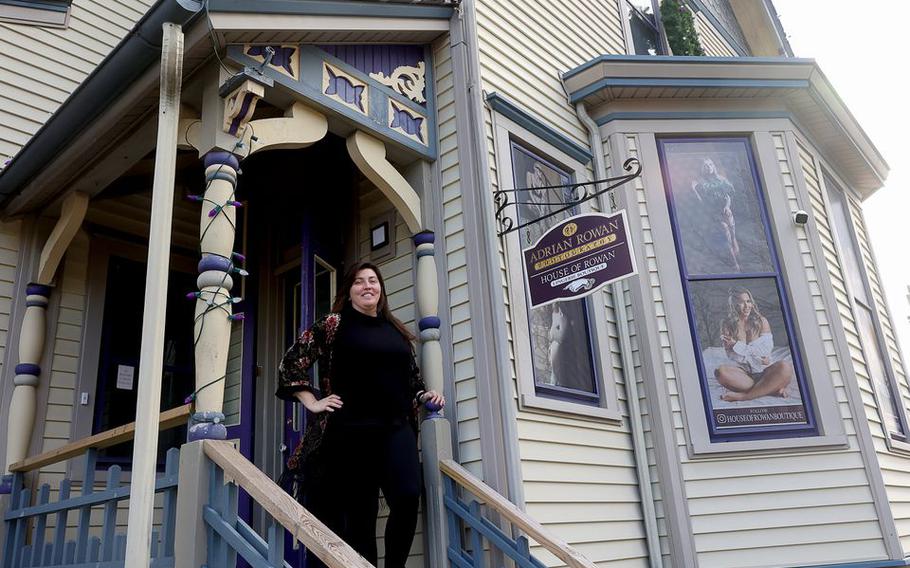 Adrian Rowan stands outside her photography studio and lingerie boutique, Jan. 18, 2022.