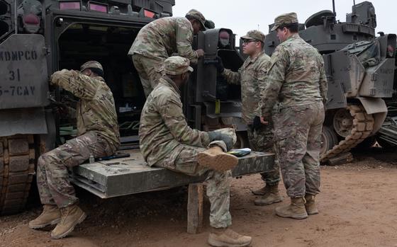 U.S. soldiers assigned to the 5th Squadron, 7th Cavalry Regiment do maintenance work on an Armored Multi-Purpose Vehicle at Camp Reedo, Estonia, March 13, 2025.