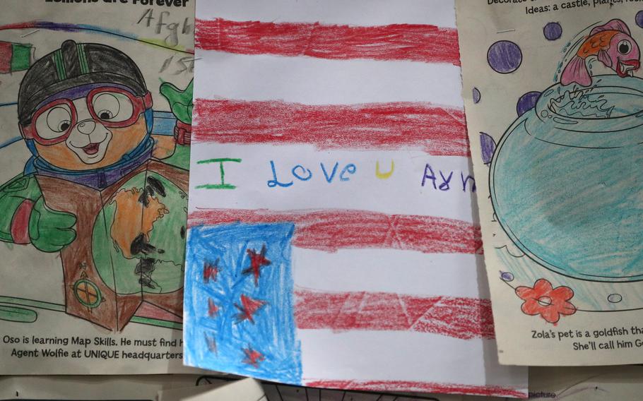Children’s drawings line the walls in the IRC where evacuees go through processing when they arriive for Operation Allies Welcome in Camp Atterbury. Photo taken Thursday, Oct. 14, 2021 at Camp Atterbury in Edinburgh. In the middle of these drawings, one drawing of an American flag with the words, “I love u army,” is seen.