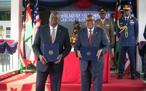 US Secretary of Defense Lloyd J. Austin, left and Kenya Cabinet Secretary for Defense Aden Duale, hold copies of a signed bilateral defense cooperation agreement, in Nairobi, Kenya, Monday Sept. 25, 2023. The U.S. and Kenya have signed a defense agreement that will see the East African nation get resources and support for security deployments as it is poised to lead a multi-national peacekeeping mission to Haiti to combat gang violence. (AP Photo/Khalil Senosi)