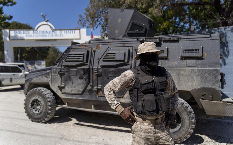 Haitian police officers patrol outside the National Police School, as a funeral ceremony is held for three police officers killed by armed gangs, in Port-au-Prince, Haiti on Jan. 31, 2023. Fourteen police officers have been killed by armed gangs since the beginning of 2023, according to the National Union of Haitian Police Officers. 