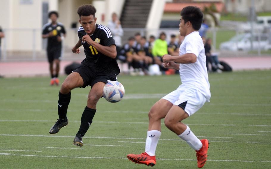 Kadena’s Yoshua Whipp tries to settle the ball against Okinawa Christian’s Jarin Ferido during Wednesday’s Okinawa boys soccer match. The Panthers won 10-1.