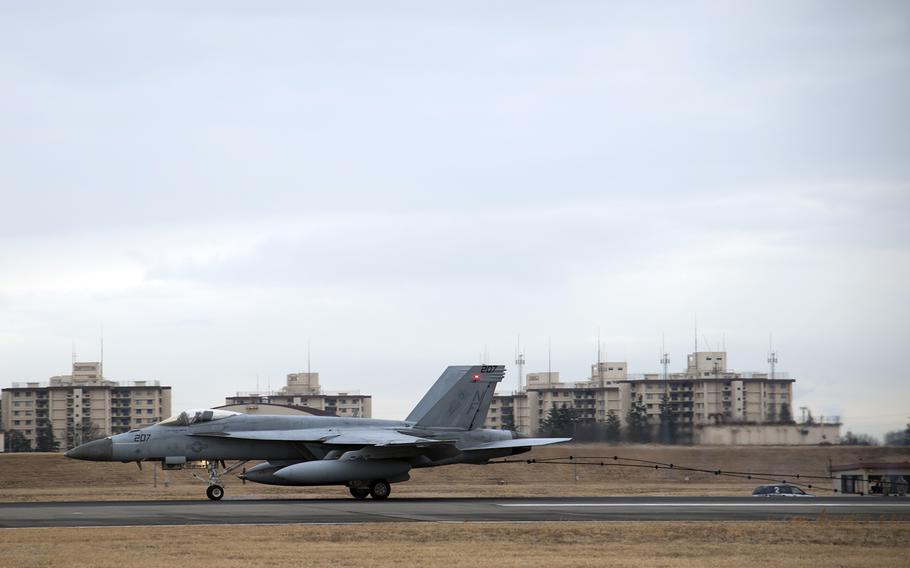 A Navy F/A-18E Super Hornet assigned to the Strike Fighter Squadron 27 hooks onto arresting cables during a test at Yokota Air Base, Japan, Feb. 4, 2022. 