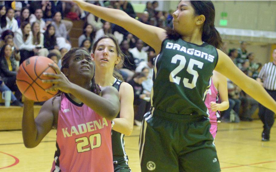 Kadena's Jayla Johnson tries to shoot against Kubasaki's Sawa Cantave and Isabella Mabie during Friday's Okinawa girls basketball game. The Dragons won 28-24, giving them a 3-1 season-series edge over the Panthers, their first in 20 seasons.