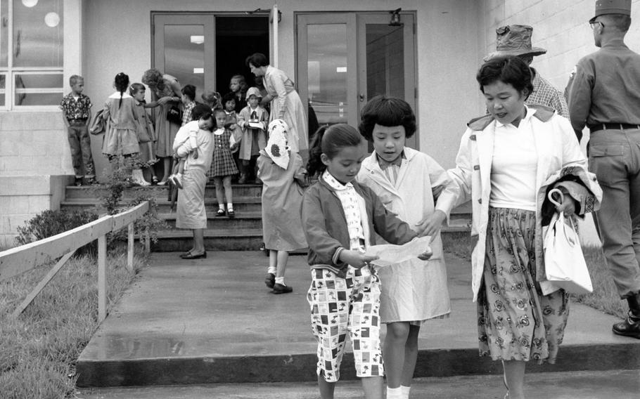 Children file out of grammar school on Aug. 29, 1960, as the first day of school comes to an end at Seoul American School.