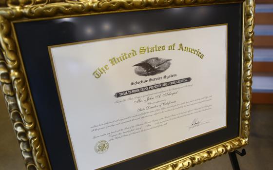 A framed appointment certificate is displayed for John A. Arbogast, the Selective Service System’s new state director for California, before his swearing in ceremony, March 13, 2023, at Joint Forces Training Base, Los Alamitos, California. Arbogast, a U.S. Coast Guard veteran and Pasadena resident who has served in a variety of community roles including city commissioner, history teacher and track coach in addition to other Selective Service Systems positions at the state and local level, was nominated for his new role by California Governor Gavin Newsom. (U.S. Air National Guard photo by Staff Sgt. Crystal Housman)
