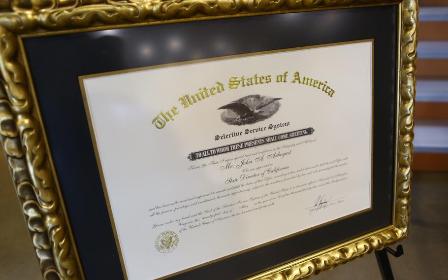 A framed appointment certificate is displayed for John A. Arbogast, the Selective Service System’s new state director for California, before his swearing in ceremony, March 13, 2023, at Joint Forces Training Base, Los Alamitos, Calif. 