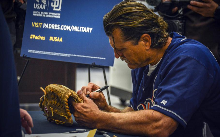 MLB Hall of Famer Trevor Hoffman signs a fan's glove during a meet-and-greet inside the main exchange at Camp Humphreys, South Korea, March 17, 2024.