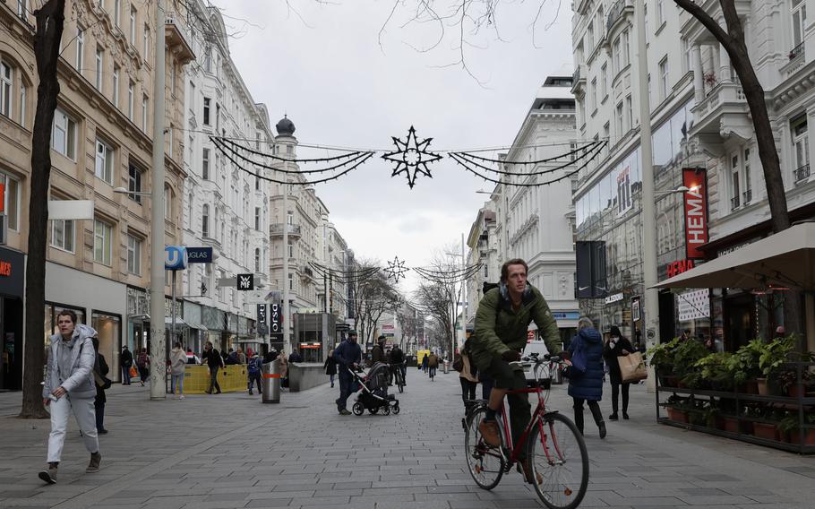 People gather on the shopping street Marienhilfer Strasse in Vienna, Austria, Friday, Nov. 19, 2021. Austrian Chancellor Alexander Schallenberg says the country will go into a national lockdown starting Monday, Nov.22, to contain a fourth wave of coronavirus cases.