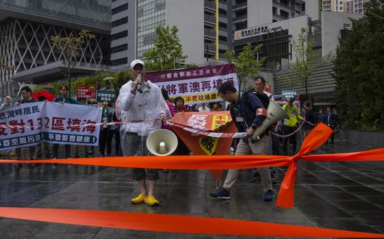 Protesters wearing number tags during a rally in Hong Kong, Sunday, March 26, 2023. Dozens of people on Sunday joined Hong Kong's first authorized demonstration against the government since the lifting of major COVID-19 restrictions under unprecedentedly strict rules, including wearing a numbered badge around their necks. (AP Photo/Louise Delmotte)
