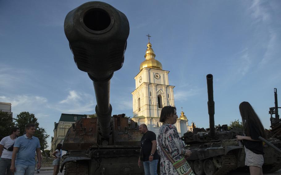 Visitors examine destroyed Russian tanks and other military equipment displayed at St. Michael's Square in Kyiv, Ukraine, on June 27, 2022. 