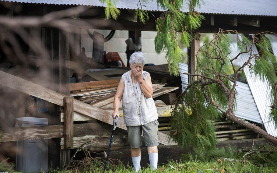 Surveying the damage for the first time, Sharon Orlando tries to hold back tears on the morning after Hurricane Ida hit her Destrehan, La., home on Monday, Aug. 30, 2021. 