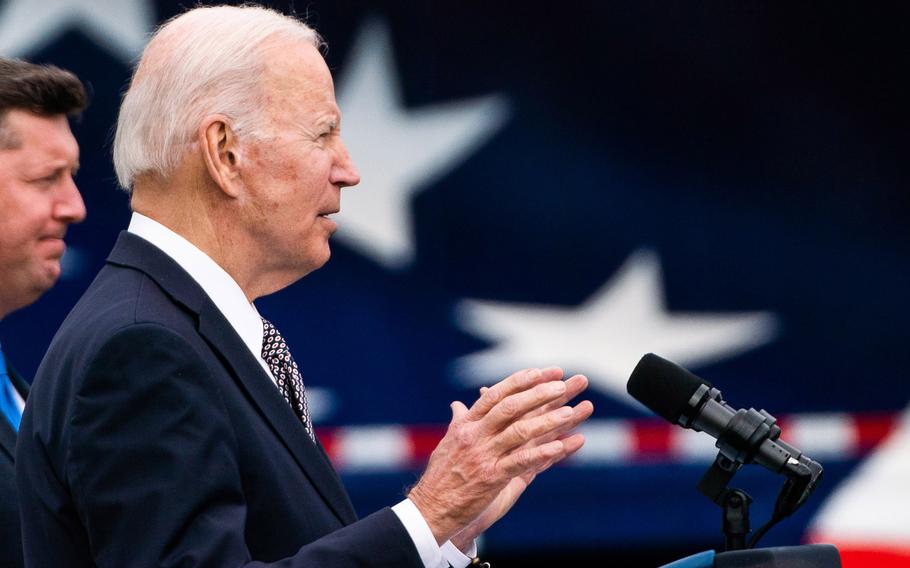 President Biden delivers remarks alongside Transportation Secretary Pete Buttigieg, left. 