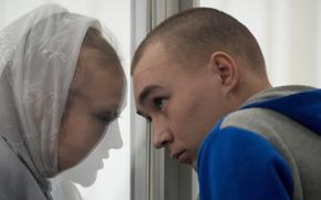 Russian Sgt. Vadim Shishimarin listens to his translator during a court hearing in Kyiv, Ukraine, Monday, May 23, 2022. The court sentenced the 21-year-old soldier to life in prison on Monday for killing a Ukrainian civilian, in the first war crimes trial held since Russia's invasion. 