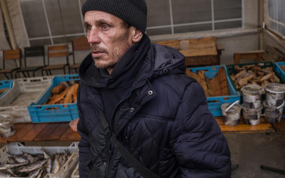 Viacheslav Borysenko stands near his fish stall in Maryanske.