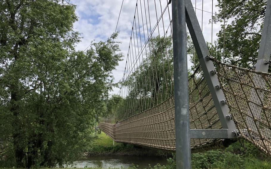 A rope bridge crosses the Nahe River at the Barfusspfad, or barefoot path, in Bad Sobernheim, Germany.