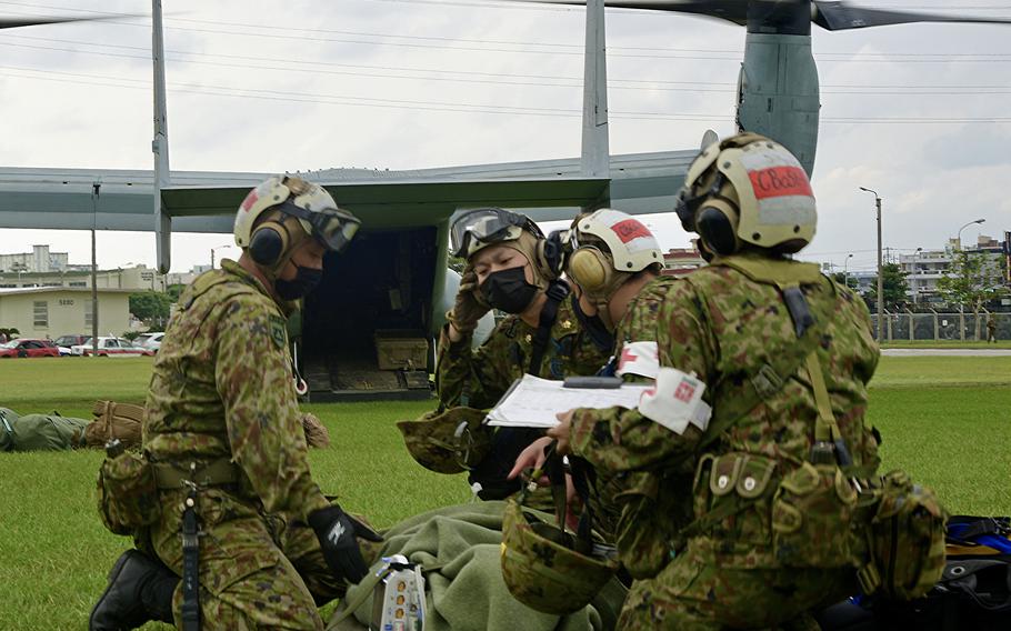 Troops with the Japan Self-Defense Force prepare to move a simulated casualty as part of emergency medical drills at Camp Foster, Okinawa, Japan, on Nov. 15, 2022. 