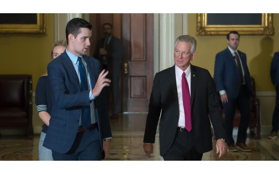 Sen. Tommy Tuberville, R-Ala., at right, walks toward the Senate Chamber on Sept. 21, 2023.