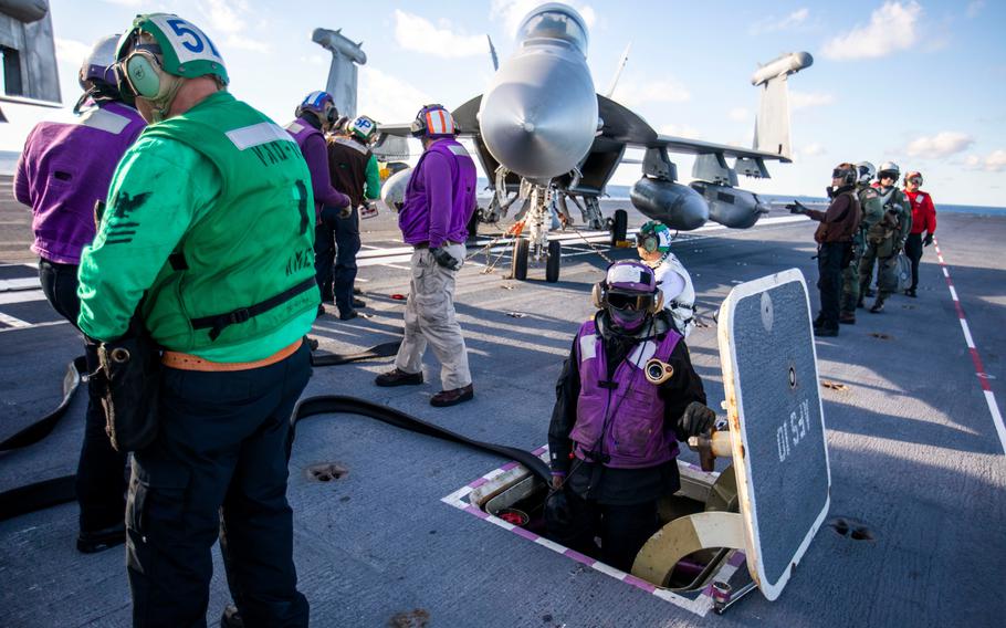 Crew members work to refuel a plane on the flight deck aboard the USS Gerald R. Ford on Thursday, Oct. 6, 2022. The fueling chambers that come directly out of the flight deck are one of many new pieces of technology utilized aboard the USS Ford.