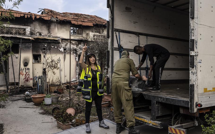 Members of the defense department and movers load up the belongings of Marcel, who was killed by Hamas on Oct. 7, 2023, in Kibbutz Beeri. 