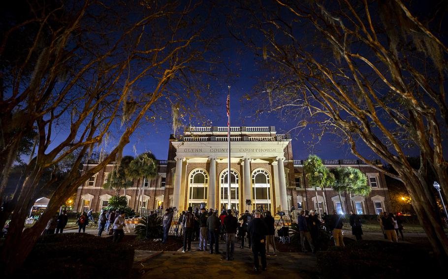 Protesters and media gather outside the Glynn County Courthouse where a jury started deliberating the trial of Greg McMichael, his son, Travis McMichael, and a neighbor, William “Roddie” Bryan, Tuesday, Nov. 23, 2021, in Brunswick, Ga. The jury began deliberating Tuesday after hearing 10 days of testimony.