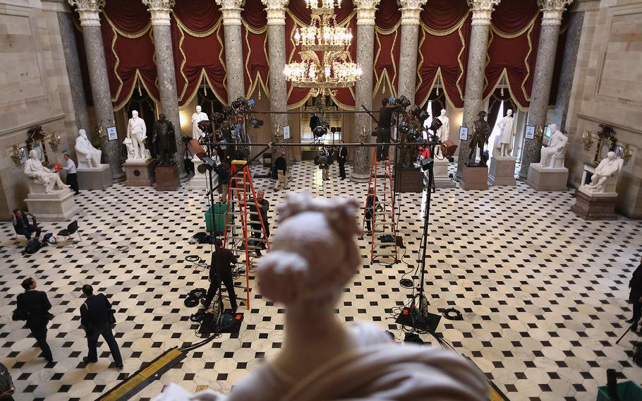 Television lighting technicians build sets inside Statuary Hall for post-speech interviews hours before U.S. President Barack Obama delivers the State of the Union address to a joint session of Congress at the U.S. Capitol on Jan. 28, 2014, in Washington, DC. 