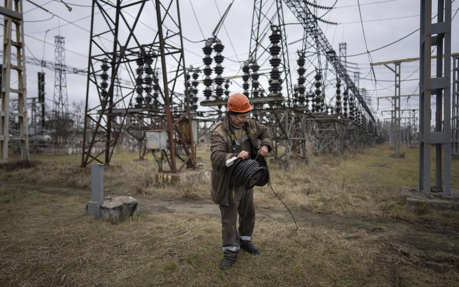A worker at a power plant, tries to repair damages after a Russian attack in central Ukraine, Jan. 5, 2023. 