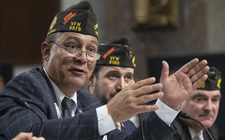 Duane Sarmiento, national commander in chief for the Veterans of Foreign Wars, speaks March 6, 2024, during a joint hearing of the Senate and House Veterans’ Affairs committees on Capitol Hill. Behind him are Ryan Gallucci, executive director of the VFW Washington office, and Michael Figlioli, the VFW’s national service director.
